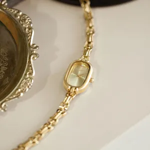 Macro view of an elegant vintage gold ladies' watch with a delicate chain strap