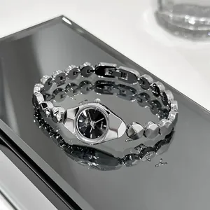 Close-up detail of silver GEDI quartz bracelet watch with minimalist black dial.