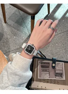 Detail view of a stylish square quartz watch with transparent case and white silicone strap