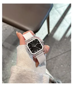 Close-up detail of a chic women's square quartz watch with white silicone strap.