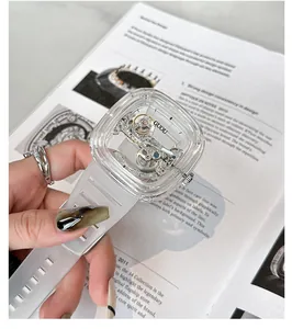 Close-up of a transparent square skeleton mechanical watch with a clear silicone strap.