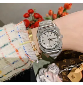 Detail shot of the Dinimi octagonal silver steel band quartz watch on a lady's wrist.