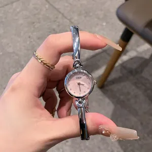 Detailed view of GEDI silver bangle watch with elegant pink dial and crystal markers