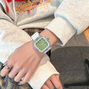 Fashionable square quartz watch with green dial and white silicone strap on wrist