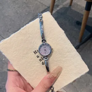 Detailed view of an elegant GEDI silver bracelet watch featuring a small lavender dial