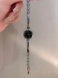 Close-up detail of GEDI minimalist silver bracelet watch with elegant black dial