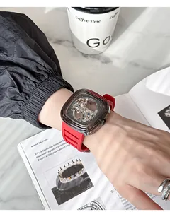 Close-up of GUOU women's mechanical watch with red silicone strap and transparent case