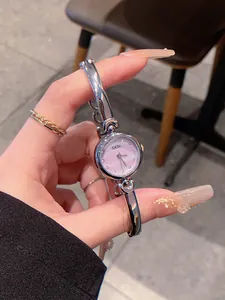 Close-up of GEDI silver bangle watch with elegant pink dial and crystal markers
