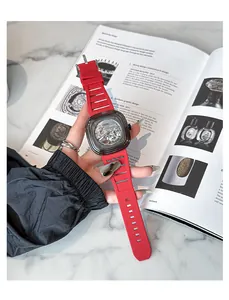 Close-up of GUOU women's mechanical style watch with transparent dial and red strap