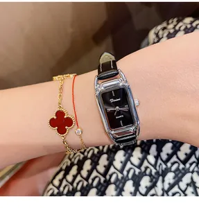 Close-up of a Dimini retro square women's quartz watch with black leather strap