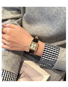 Elegant close-up view of a vintage square GUOU watch worn on a woman's wrist in a lifestyle setting