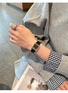 Close-up of a GUOU retro square watch with gold case and black leather strap