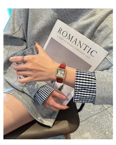 Lifestyle detail of a GUOU vintage rectangular watch featuring a red leather strap