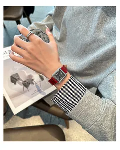Detailed shot of a GUOU vintage square watch with a red leather strap on a woman's wrist