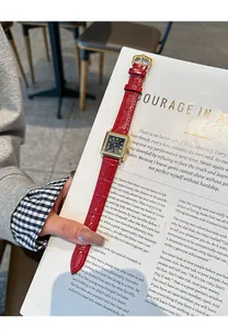 Close-up of GUOU retro square women's watch with a red leather strap on an open book.