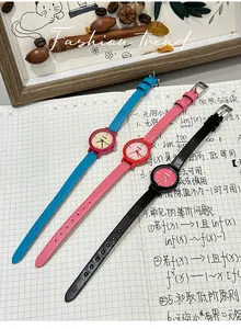 Detailed shot of three vibrant small round wristwatches in blue, pink, and black colors.