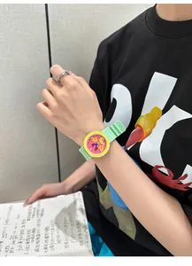 Detailed view of the cute cartoon star watch with green silicone strap on wrist
