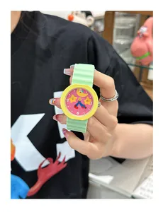 Close-up of a colorful cartoon watch featuring a green silicone strap and vibrant yellow bezel.