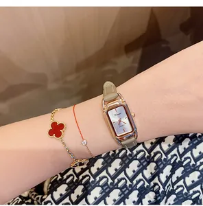 Close-up of elegant Dimini rectangular quartz watch with leather strap on wrist