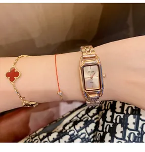Close-up detail of Dinimi rose gold steel strap quartz watch for women on wrist