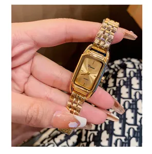 Close-up of elegant gold women's quartz watch with rectangular dial and link band