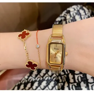 Elegant Dimini vintage gold square quartz watch for women shown on wrist with clover bracelet