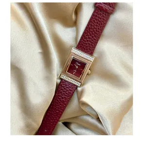 Close-up of vintage Angola red women's watch with rectangular crystal-set gold dial