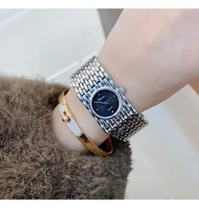 Detailed close-up of Dinimi vintage quartz jewelry watch with silver mesh strap.