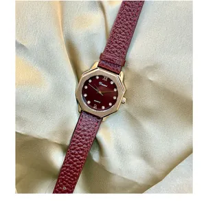 Detail of vintage Angela red ladies watch with octagonal gold case and leather strap