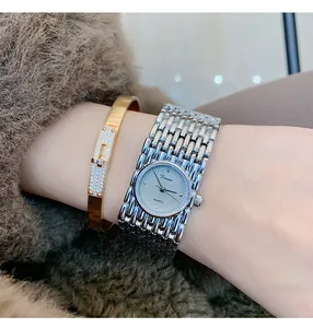 Elegant close-up of Dinimi vintage quartz watch with gold bracelet on a woman's wrist