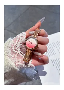 Close-up of EAVANLIN rose gold watch with gradient pink dial and glitter detail.