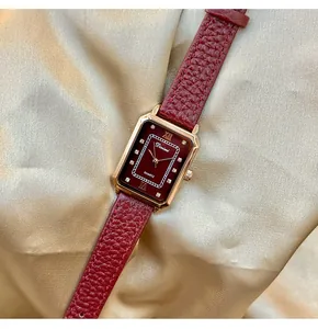 Elegant rectangular women's watch with burgundy dial and red leather strap on silk