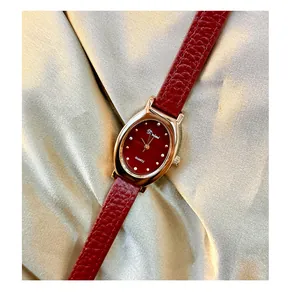 Close-up of vintage Angela red women's quartz watch with elegant red leather strap