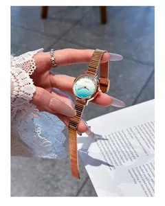 Close-up of Eavanlin women's quartz watch with teal gradient sparkle dial and rose gold band