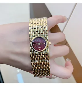 Detailed close-up of Dinimi women's quartz watch with burgundy dial and gold mesh strap.