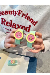 Detail shot showing two vibrant cartoon silicone watches with cake and hamburger patterns.
