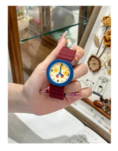 Close-up of a cute cartoon star student watch with a vibrant red silicone strap.
