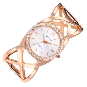 Detailed view of elegant rose gold bangle watch with crossed lines and crystal bezel