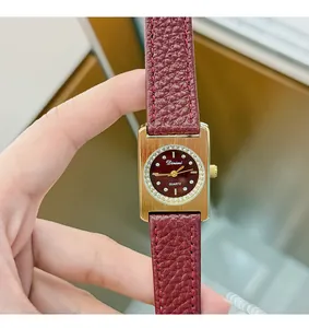 Close-up of vintage Angola red women's quartz watch with gold rectangular dial