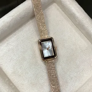 Close-up of GEDI square dial women's quartz watch featuring a textured rose gold strap
