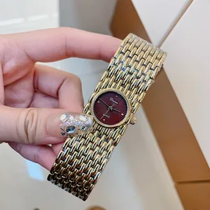 Dinimi vintage women's quartz watch featuring a gold woven bracelet and red dial