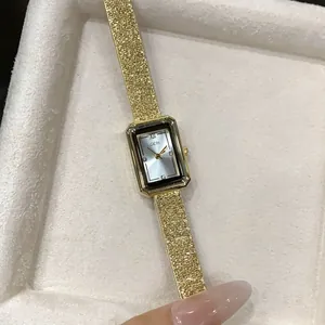 Detailed close-up of a GEDI rectangular gold women's quartz watch in an elegant gift box