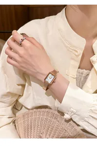 Detailed shot of a vintage rose gold rectangular quartz watch on an Asian model's wrist