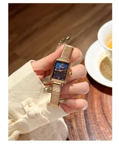 Detailed view of an elegant rose gold rectangular watch with a blue marble dial.