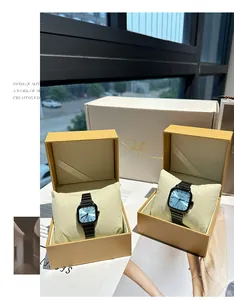 Elegant square watches with light blue dials and black straps in golden gift boxes