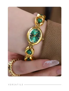 Detailed view of Gedi vintage gold bracelet watch with green dial and stone accents