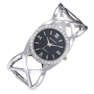 Close-up of elegant silver bangle watch with rhinestone-encrusted round black dial