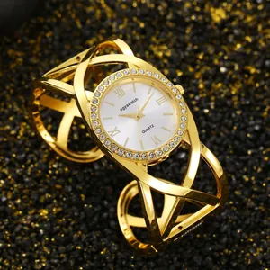 Close-up of vintage gold-tone bangle watch with rhinestone-encrusted round dial