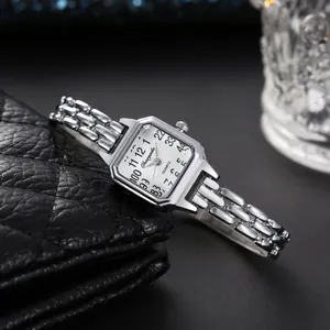 Primo piano di un orologio al quarzo quadrato argento da donna su pelle trapuntata nera