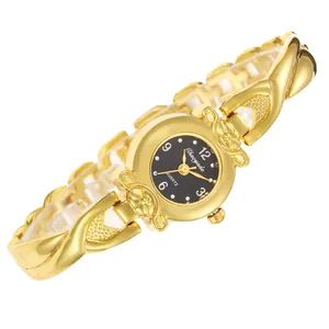Vue détaillée de la montre à quartz dorée pour femme avec bracelet croisé décoratif